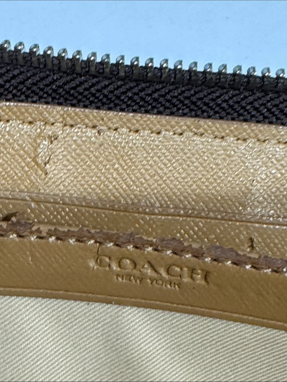Coach Brown/Tan Signature Zip Wallet with Logo Plaque tags inside.